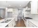 Modern kitchen featuring white cabinetry, stainless steel appliances, and granite countertops at 5072 Aspen Meadow St, Raleigh, NC 27616