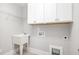 Practical laundry room featuring overhead cabinets, utility sink, and connections at 5072 Aspen Meadow St, Raleigh, NC 27616