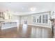 Bright and open living area showcasing hardwood floors, recessed lighting, and seamless flow to the kitchen at 5072 Aspen Meadow St, Raleigh, NC 27616