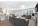 Open-concept living space with modern furnishings, a fireplace, and a view of the kitchen and dining area at 5072 Aspen Meadow St, Raleigh, NC 27616
