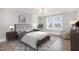 Main bedroom with neutral decor, hardwood floors, and a large window offering ample light at 5072 Aspen Meadow St, Raleigh, NC 27616