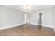 Room featuring hardwood floors, a modern chandelier, and a view to additional rooms at 5072 Aspen Meadow St, Raleigh, NC 27616