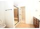 Bathroom with tiled shower, vanity, and open doorway to a large closet at 525 Rockcastle Dr, Cary, NC 27519