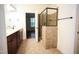 Bathroom featuring double vanity, tiled shower, and an open door at 525 Rockcastle Dr, Cary, NC 27519