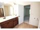Bathroom with dual sink vanity, walk-in shower, and view to the bedroom at 525 Rockcastle Dr, Cary, NC 27519