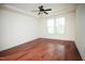 An airy bedroom with hardwood floors, ceiling fan, and a window at 525 Rockcastle Dr, Cary, NC 27519