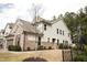 Inviting two-story home with a brick facade, complemented by a well-manicured lawn and a black fence at 525 Rockcastle Dr, Cary, NC 27519