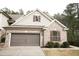 Charming brick home featuring a two-car garage, complemented by lush greenery and traditional shutters at 525 Rockcastle Dr, Cary, NC 27519