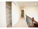 Upstairs hallway with carpet and access to the walk-in closet at 525 Rockcastle Dr, Cary, NC 27519