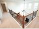 Hallway overlooking the living room with carpeted floor and decorative railings at 525 Rockcastle Dr, Cary, NC 27519
