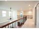 Bright hallway featuring neutral paint, carpet flooring, and an elegant railing at 525 Rockcastle Dr, Cary, NC 27519