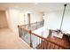 Upstairs hallway overlooking downstairs. Features iron railing, access to rooms, and new carpet at 525 Rockcastle Dr, Cary, NC 27519