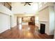 Open-concept living area with a fireplace, hardwood floors, and abundant natural light with kitchen view at 525 Rockcastle Dr, Cary, NC 27519