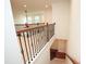 Carpeted staircase with decorative wood and metal railing overlooking living space at 525 Rockcastle Dr, Cary, NC 27519