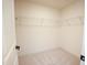 Bright, carpeted walk-in closet with ample storage space and wire shelving at 525 Rockcastle Dr, Cary, NC 27519