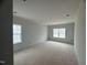 Bedroom with unfinished flooring and two windows at 5344 Salem Woods Dr # 20, Graham, NC 27253