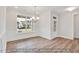 Dining room featuring wood floors, a chandelier, large windows, and white wainscoting at 5344 Salem Woods Dr # 20, Graham, NC 27253