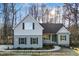 New two-story home featuring neutral siding, black shutters, covered front porch, and professional landscaping at 5344 Salem Woods Dr # 20, Graham, NC 27253