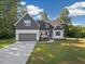 Charming home featuring a two-car garage and a mix of gray and white siding at 5344 Salem Woods Dr # 20, Graham, NC 27253