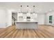 Modern kitchen with a large island, white cabinets, and stainless steel appliances at 5344 Salem Woods Dr # 20, Graham, NC 27253
