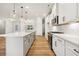 Stylish kitchen featuring white cabinets, a large island, and modern lighting fixtures at 5344 Salem Woods Dr # 20, Graham, NC 27253