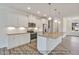 Bright kitchen features stainless appliances, white cabinets, granite countertops, and kitchen island with sink at 5344 Salem Woods Dr # 20, Graham, NC 27253