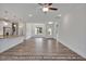 Open-concept living room with hardwood floors, modern fixtures, and access to kitchen at 5344 Salem Woods Dr # 20, Graham, NC 27253