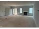 Unfinished living room featuring white trim, fireplace, and a sliding door to the deck at 5344 Salem Woods Dr # 20, Graham, NC 27253