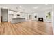 Open living room with a fireplace, hardwood floors, and a view of the kitchen area at 5344 Salem Woods Dr # 20, Graham, NC 27253