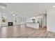 Open living room features hardwood floors, fireplace, ceiling fan, and access to the kitchen at 5344 Salem Woods Dr # 20, Graham, NC 27253