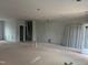 Unfinished living room featuring white trim, fireplace, and sliding glass doors at 5344 Salem Woods Dr # 20, Graham, NC 27253