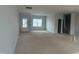 Unfinished living room features white walls, trim, and a view of the front yard through the window at 5344 Salem Woods Dr # 20, Graham, NC 27253