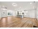 Open-concept living space with hardwood floors connecting the kitchen and dining areas at 5344 Salem Woods Dr # 20, Graham, NC 27253