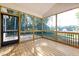 Screened patio with wood flooring and black metal railing and screen door at 5344 Salem Woods Dr # 20, Graham, NC 27253