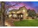 Twilight view of the home's backyard featuring an outdoor kitchen and pergola seating at 601 Ballad Creek Ct, Cary, NC 27519