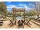 This outdoor space is perfect for entertaining with pergola, fire pit, and chairs at 601 Ballad Creek Ct, Cary, NC 27519