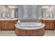 Bright bathroom featuring a large soaking tub, double sinks, and modern fixtures at 601 Ballad Creek Ct, Cary, NC 27519