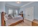 Cozy bedroom with natural light, light blue walls, crown molding, and a bed at 601 Ballad Creek Ct, Cary, NC 27519
