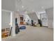 Large, carpeted bonus room with gym and bar area on the third floor at 601 Ballad Creek Ct, Cary, NC 27519