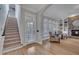 Open entryway to living room features an open staircase, and arched window details at 601 Ballad Creek Ct, Cary, NC 27519