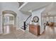 Open foyer with hardwood floors, curved staircase, and arched doorways at 601 Ballad Creek Ct, Cary, NC 27519