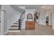 Elegant foyer with curved staircase, hardwood floors, and decorative accents at 601 Ballad Creek Ct, Cary, NC 27519