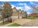 Exterior view of the home with a driveway, basketball hoop, and three-car garage at 601 Ballad Creek Ct, Cary, NC 27519