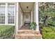 Covered front porch with stone steps, bench, and lush landscaping at 601 Ballad Creek Ct, Cary, NC 27519