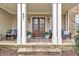 Inviting front porch with seating, stone accents, and a double-door entryway at 601 Ballad Creek Ct, Cary, NC 27519