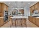 This kitchen has a large center island with a marble countertop and wooden cabinets around the perimeter at 601 Ballad Creek Ct, Cary, NC 27519