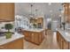 Large open kitchen featuring an island, stainless appliances and views of the breakfast area and stairs at 601 Ballad Creek Ct, Cary, NC 27519