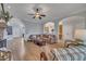 This living room has a brick fireplace, wood floors and an arched opening to the kitchen at 601 Ballad Creek Ct, Cary, NC 27519