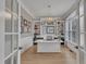 Bright office with custom built-ins, decorative chandelier, and hardwood floors at 601 Ballad Creek Ct, Cary, NC 27519