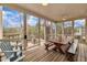 Enjoy this screened porch with a wooden table, benches, and a ceiling fan at 601 Ballad Creek Ct, Cary, NC 27519